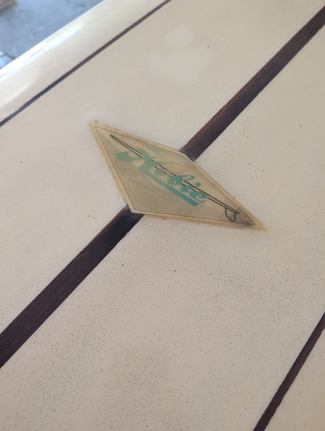 Original Hobie diamond label under fresh gloss on the restored longboard