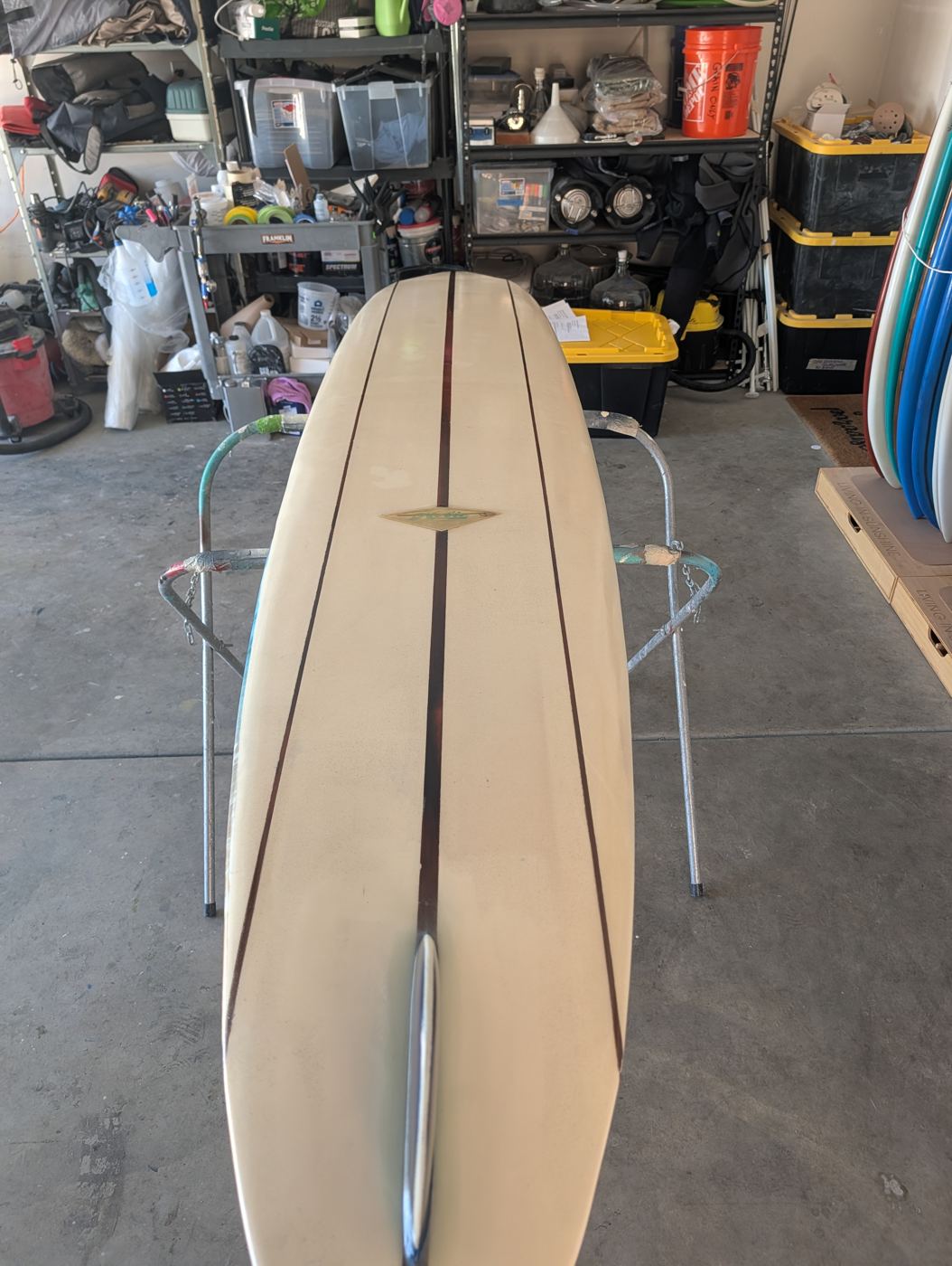 The longboard reshaped, re-glassed and glossed, stringers showing